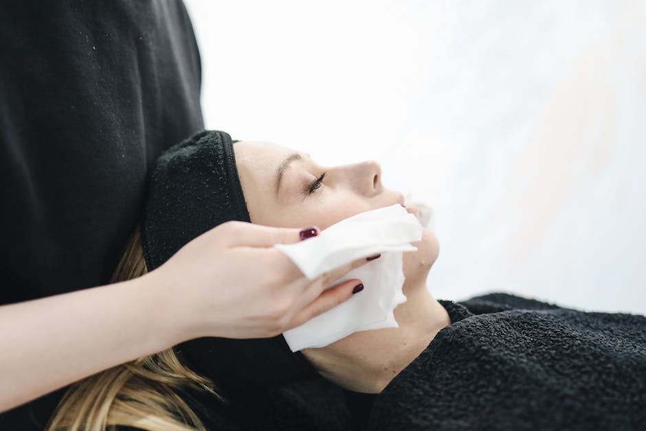 Side view of a woman enjoying a relaxing facial treatment at a spa