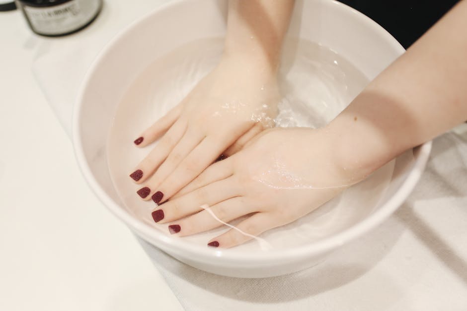 Luxurious hand spa treatment with elegant manicured nails submerged in a soothing soak